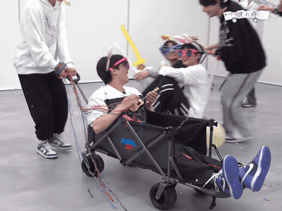 A Group Of People Are Playing With A Wagon That Says ' Nike ' On The Front GIF