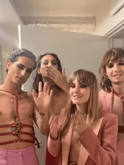 A Group Of People Are Posing For A Picture And One Of Them Has A Tattoo On His Chest That Says " Allow Dream " . GIF
