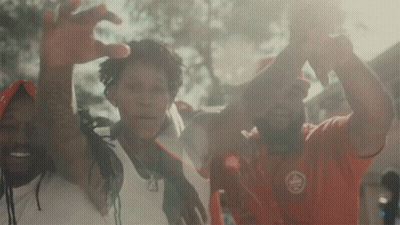 A Group Of People Are Posing For A Picture And One Of Them Is Wearing A Red Shirt That Says ' Canada ' On It GIF