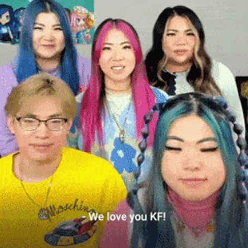 A Group Of People Are Posing For A Picture And One Of Them Is Wearing A Yellow Shirt That Says We Love You Kf GIF