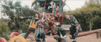 A Group Of People Are Posing For A Picture In A Playground . GIF