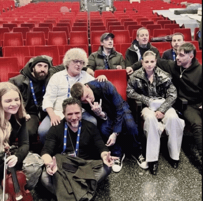 A Group Of People Are Posing For A Picture In A Theater GIF