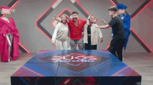 A Group Of People Are Posing For A Picture In Front Of A Sign That Says Duos Paradise GIF