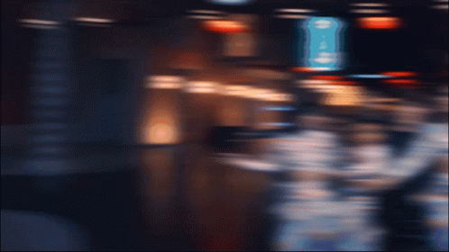 A Group Of People Are Posing For A Picture In Front Of A Sign That Says ' George 'S ' GIF