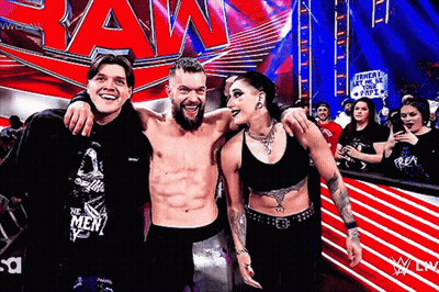 A Group Of People Are Posing For A Picture In Front Of A Sign That Says Raw GIF