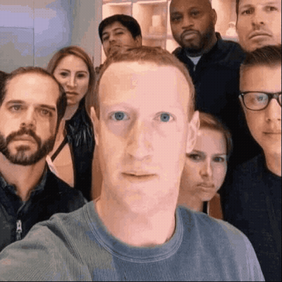 A Group Of People Are Posing For A Picture With A Man In The Middle Making A Face . GIF