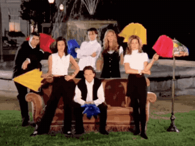 A Group Of People Are Posing For A Picture With Umbrellas In Front Of A Fountain GIF