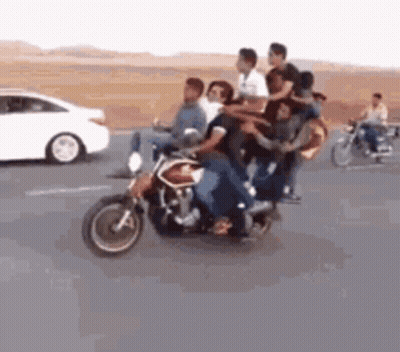 A Group Of People Are Riding A Motorcycle On A Highway . GIF