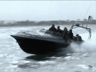 A Group Of People Are Riding In A Boat On A River . GIF