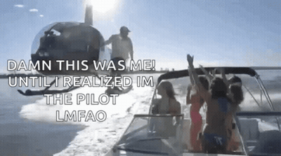 A Group Of People Are Riding On A Boat In The Water With A Helicopter Flying In The Background . GIF