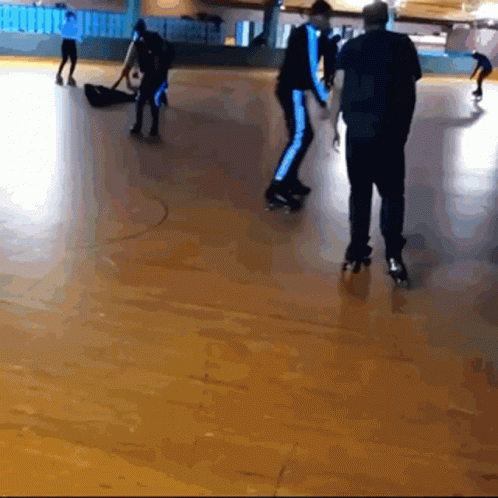 A Group Of People Are Rollerblading On A Roller Rink GIF