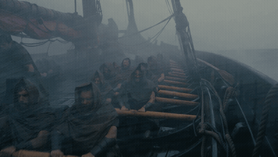 A Group Of People Are Rowing A Boat In The Water GIF