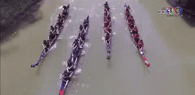 A Group Of People Are Rowing Boats On A River With The Number 33 On The Bottom GIF