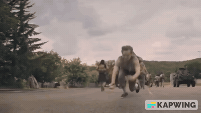 A Group Of People Are Running Down A Street With A Kapwing Logo In The Corner GIF