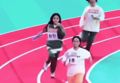 A Group Of People Are Running On A Track And One Of Them Is Wearing A Number 1 Shirt . GIF