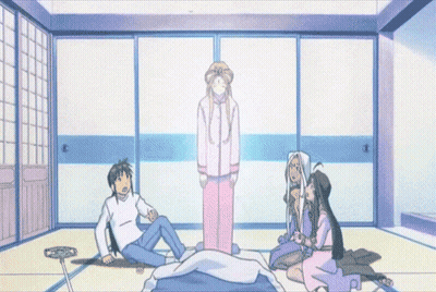 A Group Of People Are Sitting Around A Bed With A Ghost In The Background GIF