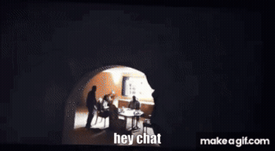 A Group Of People Are Sitting Around A Table In A Dark Room And The Words Hey Chat Are Visible On The Screen GIF