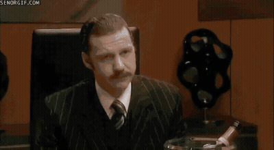 A Group Of People Are Sitting Around A Table With A Sign That Says Senorgif.com On It GIF