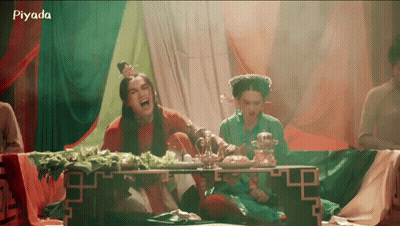 A Group Of People Are Sitting Around A Table With The Word Piyada On The Bottom Right GIF