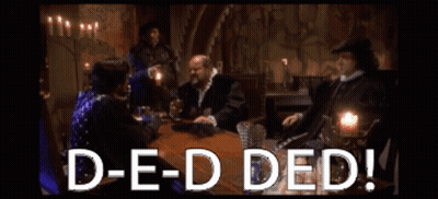 A Group Of People Are Sitting Around A Table With The Words D-E-D Ded GIF