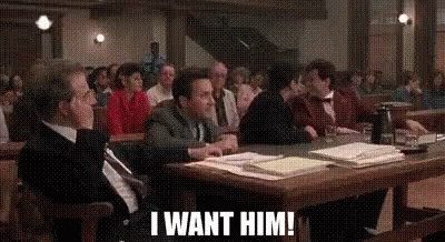 A Group Of People Are Sitting At A Table In A Courtroom And One Of Them Is Saying `` I Want Him ! '' GIF