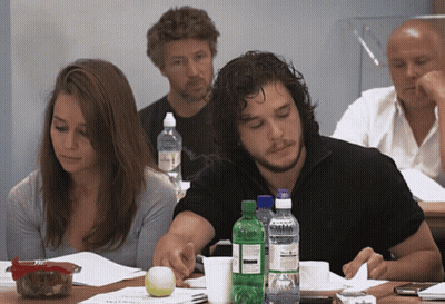 A Group Of People Are Sitting At A Table With Bottles Of Water Including One That Says Sprite GIF