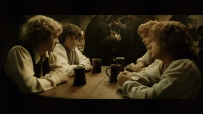 A Group Of People Are Sitting At A Table With Mugs Of Coffee . GIF
