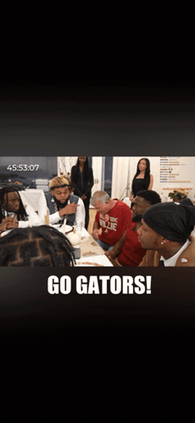 A Group Of People Are Sitting At A Table With The Words Go Gators On The Bottom GIF