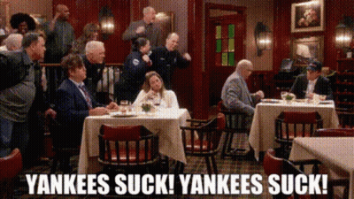 A Group Of People Are Sitting At Tables In A Restaurant With The Words Yankees Suck Yankees Suck Written On The Bottom GIF
