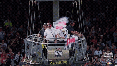 A Group Of People Are Sitting In A Cage That Says Gainbridge GIF