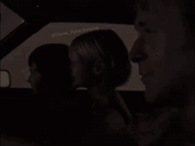 A Group Of People Are Sitting In A Car . GIF