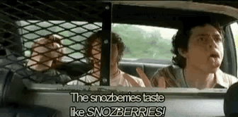 A Group Of People Are Sitting In A Car With A Fence Behind Them . GIF