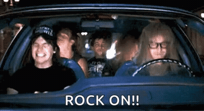 A Group Of People Are Sitting In A Car With The Words `` Rock On '' Written On It . GIF