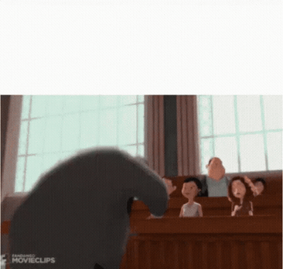 A Group Of People Are Sitting In A Classroom With A Cartoon Character Standing In Front Of Them . GIF