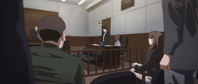 A Group Of People Are Sitting In A Courtroom With A Man Standing Behind A Fence GIF