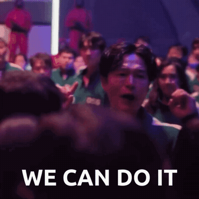 A Group Of People Are Sitting In A Dark Room And A Man Is Screaming In The Middle Of The Crowd . GIF
