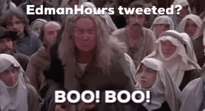 A Group Of People Are Sitting In A Room And A Woman Is Standing In Front Of Them . GIF