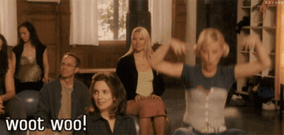 A Group Of People Are Sitting In A Room And One Of Them Is Saying Woot Woo . GIF