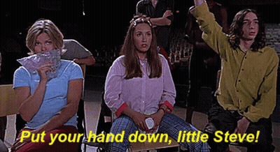A Group Of People Are Sitting In A Room With The Words `` Put Your Hand Down , Little Steve '' . GIF