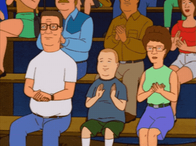 A Group Of People Are Sitting In A Stadium Clapping GIF