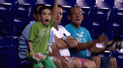 A Group Of People Are Sitting In A Stadium Watching A Game And One Of Them Is Wearing A Hollister Shirt GIF