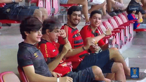 A Group Of People Are Sitting In A Stadium With A Live Fc Logo On The Bottom GIF