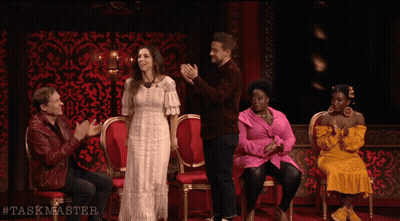 A Group Of People Are Sitting In Chairs And Applauding With The Hashtag Taskmaster On The Bottom GIF