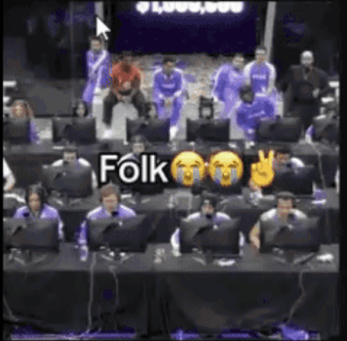 A Group Of People Are Sitting In Front Of Computer Monitors And A Sign That Says Folk On It GIF