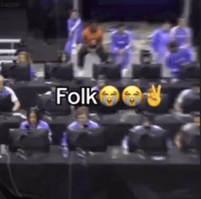 A Group Of People Are Sitting In Front Of Computer Monitors And A Sign That Says Folk GIF