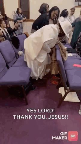 A Group Of People Are Sitting In Purple Chairs In A Church And A Woman Is Kneeling On A Chair . GIF