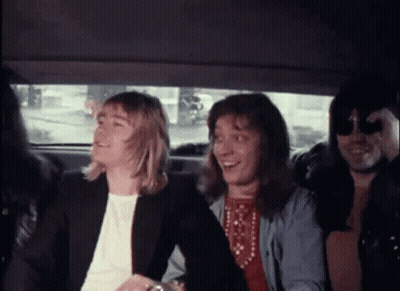 A Group Of People Are Sitting In The Back Of A Car Laughing . GIF
