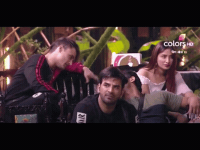 A Group Of People Are Sitting On A Bench With A Sign That Says Colors Hd On It GIF