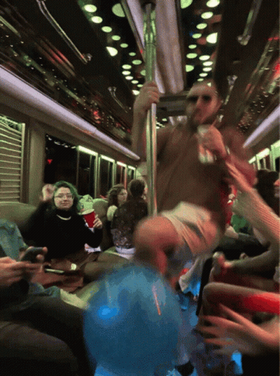 A Group Of People Are Sitting On A Bus And One Of Them Is Holding A Red Cup GIF