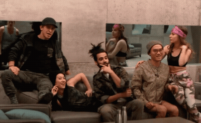 A Group Of People Are Sitting On A Couch And One Of Them Is Wearing A Headband GIF